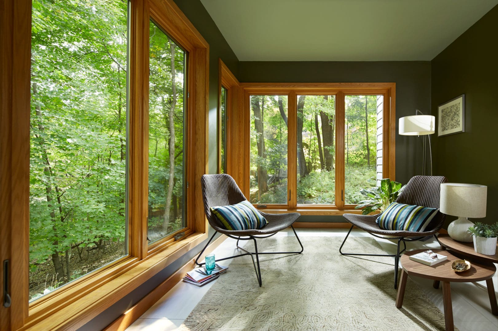 Indoor patio area with large wood-frame windows.