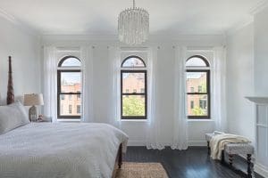 three double hung windows on bedroom of home